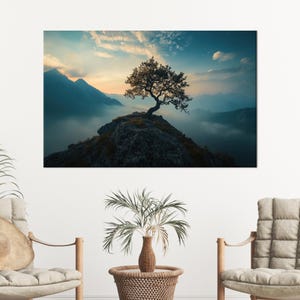 May include: A scenic canvas print featuring a lone tree atop a rocky peak, set against a backdrop of misty mountains and a vibrant sky. The artwork captures a serene landscape with a blend of blues, greens, and golden hues.
