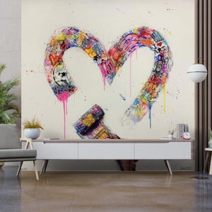 May include: A large, colorful heart-shaped graffiti art piece with the words "I Love Art" visible. The artwork features a vibrant mix of colors and drips, with a paint roller at the bottom. The piece is displayed on a wall in a modern living room setting.