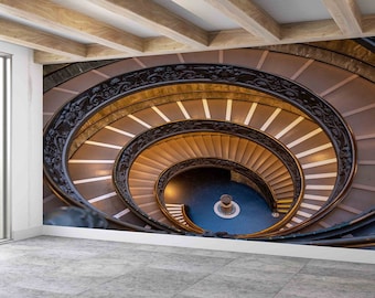 May include: A spiral staircase with a dark wood railing and light brown steps. The staircase is lit from above, casting shadows on the steps.