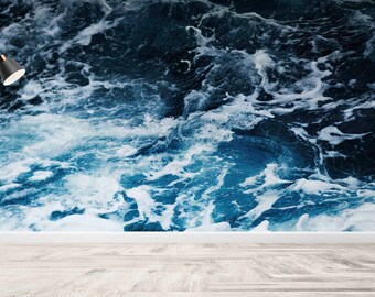 May include: A black floor lamp with a white shade sits in front of a wall with a blue and white ocean wave pattern.
