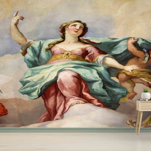 May include: A large wall mural featuring a Renaissance-style painting of a woman in flowing robes, surrounded by clouds and cherubs. The woman is reaching upwards, with a teal and pink color palette.