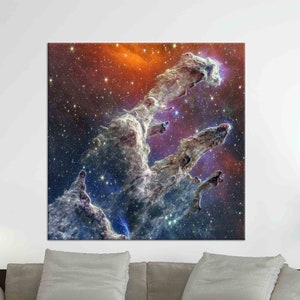 May include: A vibrant nebula with swirling clouds of gas and dust, illuminated by bright stars. The nebula is a mix of blue, purple, and orange hues, creating a stunning cosmic landscape.