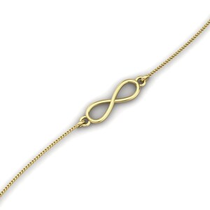 Puede incluir: Un collar de oro con un colgante de símbolo de infinito y una cadena delicada.