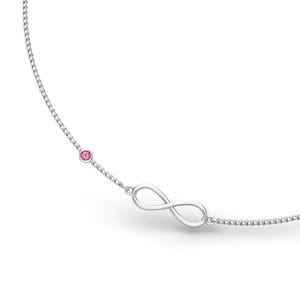 May include: A silver necklace featuring an infinity symbol pendant and a small pink gemstone. The delicate chain is visible against a white background, highlighting the jewelry's elegant design.