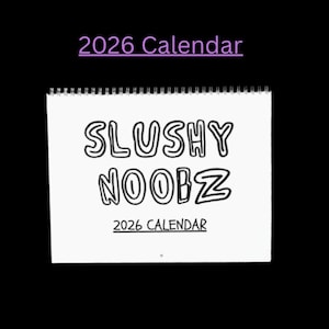 May include: A white, spiral-bound calendar featuring the words "SLUSHY NOOBZ" in bold, outlined letters. The text "2026 Calendar" is written above and below the main text. The background is black.
