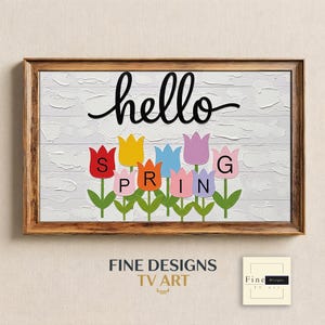 Puede incluir: Impresión artística enmarcada con un fondo blanco texturizado y la palabra "hello" en escritura negra. Debajo, recortes de tulipanes de colores deletrean "SPRING". La obra de arte incluye el texto "FINE DESIGNS TV ART".