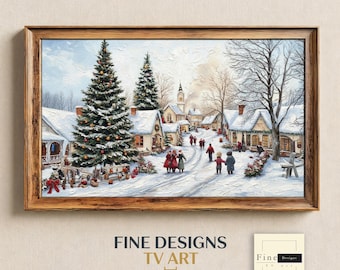 Op de afbeelding: Een ingelijst landschapsschilderij met een besneeuwd dorpsgezicht, een grote versierde kerstboom, huisjes bedekt met sneeuw en figuren die over een pad lopen. Het kunstwerk heeft een textuurrijke olieverfstijl met een houten lijst.