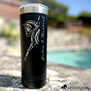 May include: Black stainless steel tumbler with a silver engraved design of a horse jumping. The text "Julia & Kasteel" is engraved on the side of the tumbler.