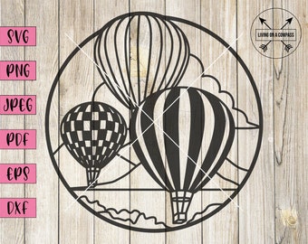 May include: Black and white silhouette of three hot air balloons in a circle. The balloons are flying over a landscape with clouds. The text "LIVING ON A COMPASS" is in the top right corner of the image.