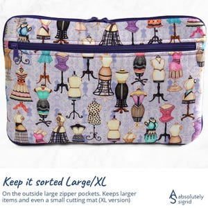 Pode incluir: Uma bolsa retangular com z&iacute;per com um fundo roxo claro com um padr&atilde;o repetido de manequins vintage em v&aacute;rias cores e estilos. A bolsa tem um z&iacute;per e acabamento roxo escuro. O texto na parte inferior diz "Keep it sorted Large/XL".