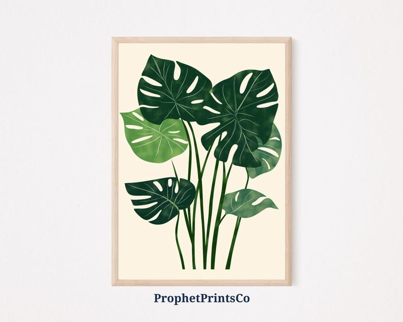 May include: A digital illustration of a cluster of green monstera leaves on a cream background. The leaves are dark green with lighter green veins and edges. The illustration is framed with a light wood frame.