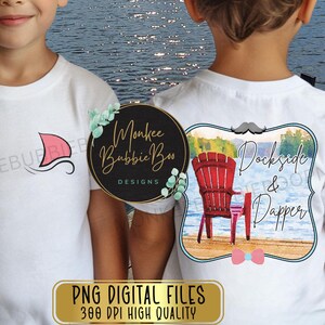 May include: Two white t-shirts with different designs. The first shirt has a red and white sailboat graphic. The second shirt has a watercolor illustration of a red Adirondack chair with a lake scene and the text "Dockside & Dapper".