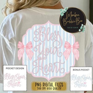 May include: A white t-shirt with a blue and white striped design featuring the text "Bless Your Heart" in pink script. Two pink bows are on either side of the text. The design is for a pocket on the shirt. The text "Monkee Babbie Boo Designs" is in a circle on the right side of the shirt.