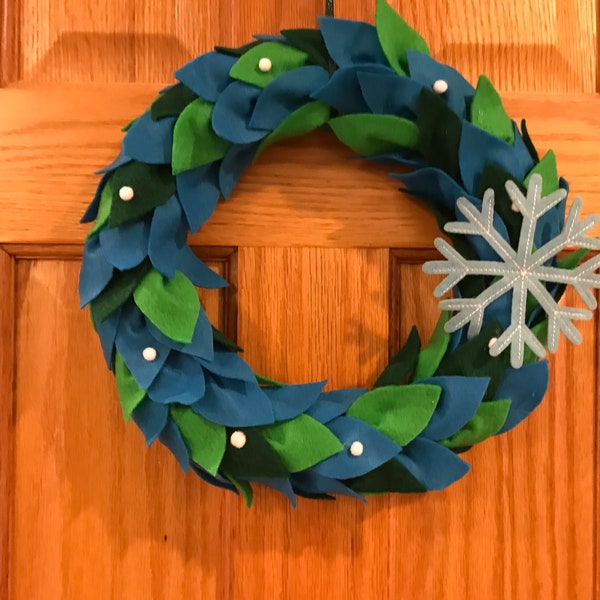 Holiday felt wreath in festive blues and greens with a pop of white