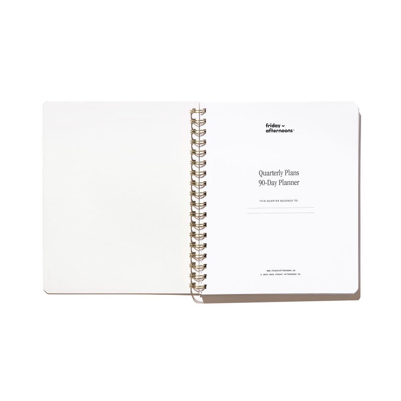 Opening title page of the Quarterly Plans 90-Day Planner with gold spiral binding, white interior pages, and minimalist Friday Afternoons branding.