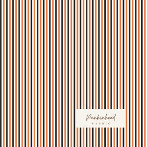 May include: Fabric with a vertical stripe pattern in black, orange, and white. The fabric has a repeating pattern of thin stripes. The text "Punkinhead Fabric" is in a rectangular box in the lower right corner.