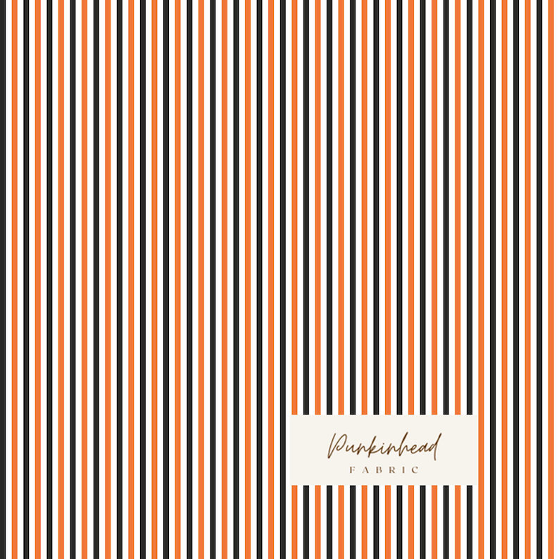 May include: Fabric with a vertical stripe pattern in black, orange, and white. The fabric has a repeating pattern of thin stripes. The text "Punkinhead Fabric" is in a rectangular box in the lower right corner.