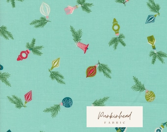 May include: A turquoise fabric with a repeating pattern of green pine branches and colorful Christmas ornaments. The fabric has the text "Pumpkinhead Fabric" in a white rectangle.