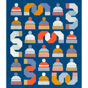 May include: A quilted blanket with a blue background features a pattern of winter hats and scarves in orange, white, and blue. The word "snow" is spelled out with the scarves. The hats have striped brims and pom-poms.