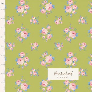 May include: A green fabric with a repeating pattern of pink and blue floral bouquets. The fabric is labeled "Pumpkinhead Fabric".