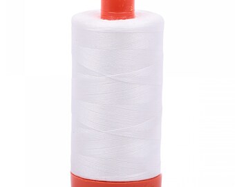 May include: A white spool of thread with an orange plastic top and bottom.