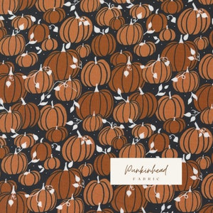 May include: A black fabric with a repeating pattern of orange pumpkins with white stems and leaves. The fabric has the text "Pumpkinhead Fabric" in white.