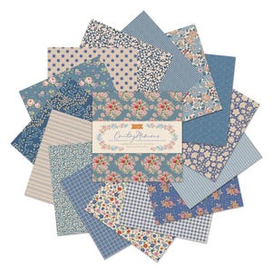 May include: A collection of fabric squares in various blue and beige patterns, including floral, polka dot, and striped designs. The center features a package with the text "Counting Memories" and floral illustrations. Ideal for quilting and crafting projects.