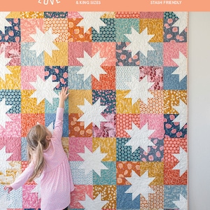 May include: A quilt pattern called "Star Pop II" by Emily Dennis. The quilt is made with a variety of colorful fabrics and features a star design. The quilt is available in baby, throw, twin, queen, and king sizes.