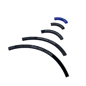 May include: A collection of curved, black plastic targets. Each target has the words "Knocked Down" printed in white, with a blue target reading "Priority Target". The targets are arranged in a descending arc.