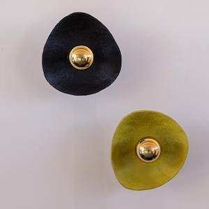 Irregular and organic wall lamp, from paper mache with golden lightbulb
