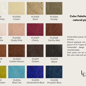 May include: A colour palette sample with sixteen squares of colour, including Oyster White, Cherry, and Prussian Blue. Text reads "Handcrafted pieces that blend art and function."