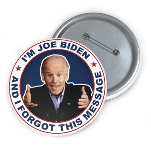 May include: A round button with a blue background and a white circle in the center. The white circle has a red star on each side and the text "I'm Joe Biden and I forgot this message" in white. A photo of Joe Biden is in the center of the circle.