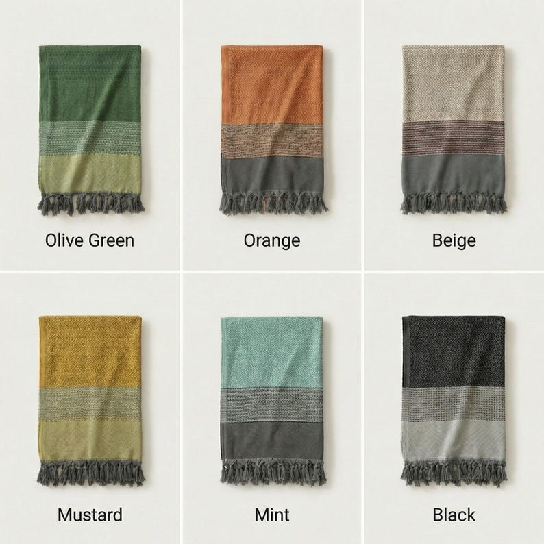 May include: A collection of six folded throw blankets in various colors. Each blanket features a striped design with a fringed edge. Colors include olive green, orange, beige, mustard, mint, and black. The name of each color is printed below the blanket.