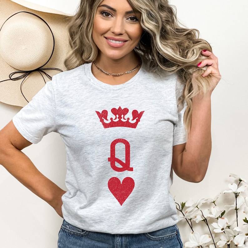 May include: A heather grey t-shirt with a red queen of hearts graphic. The graphic features a crown, the letter Q, and a heart.