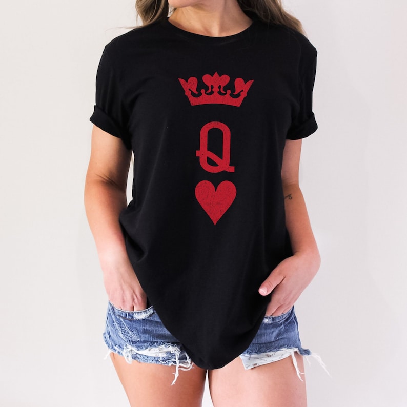 May include: Black t-shirt with a red queen of hearts graphic. The graphic features a crown, the letter Q, and a heart.