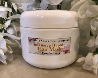 May include: White jar with a gold label that reads "Organic Skin Care Company Intensive Repair Hair Mask Pure Sensation".