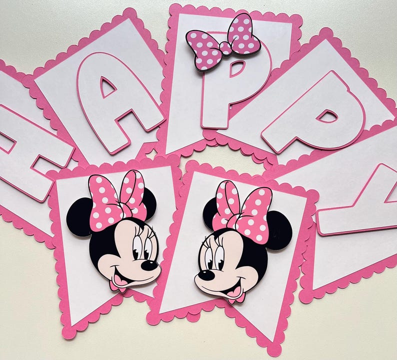 May include: Pink and white banner with the word "Happy" in white letters and two images of Minnie Mouse with pink polka dot bows.