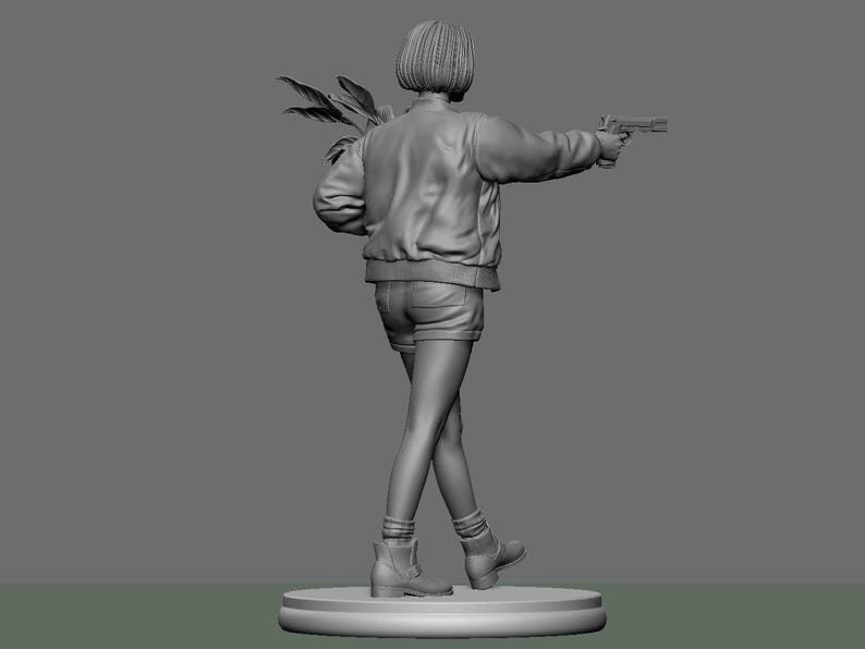 May include: A grayscale 3D-printed figurine of a person holding a handgun and a bundle of leaves. The figure is wearing a bomber jacket, shorts, and boots, standing on a circular base. The pose suggests action.