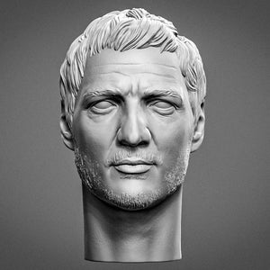 May include: A monochromatic grey sculpture of a human head featuring short, textured hair, a furrowed brow, and a light stubble beard. The facial features include blank, pupil-less eyes, a straight nose, and a neutral expression on the face.
