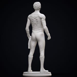 May include: A white statue of a superhero figure, viewed from the back. The figure is wearing a form-fitting suit with detailed paneling and a spider emblem on the back. The statue is on a circular base against a black background.