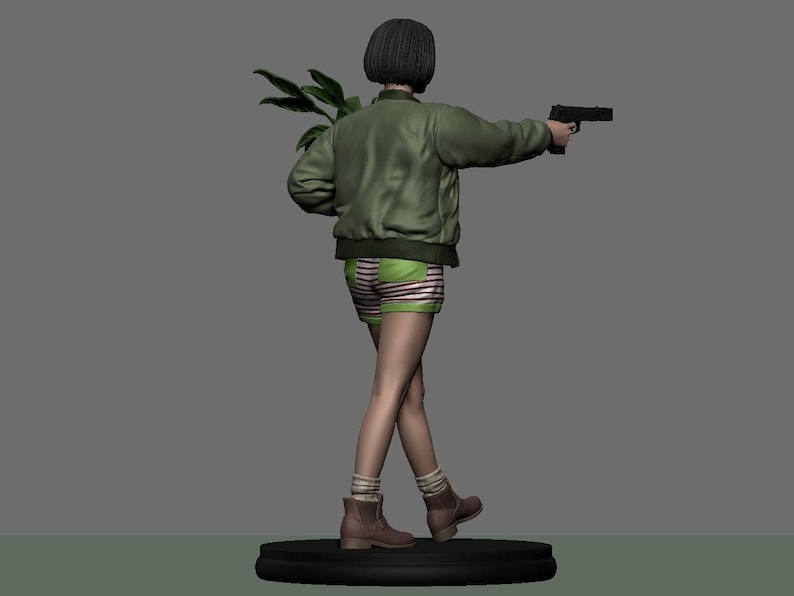 May include: A figurine of a person in a green bomber jacket, striped shorts, and boots, holding a handgun and a plant. The figure has short black hair and is standing on a black circular base. The background is a solid gray.