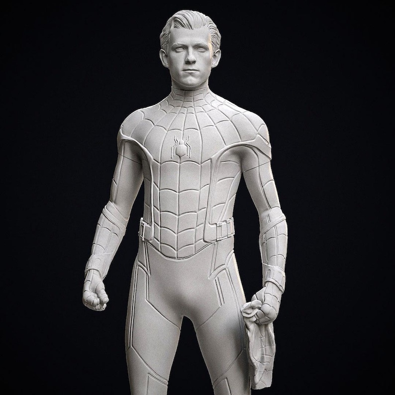 May include: A light gray statue of a superhero in a form-fitting suit with a spiderweb design. The figure is holding a mask in one hand and has a stern expression. The statue is set against a dark background.