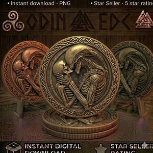 May include: A circular bronze-toned medallion featuring a relief sculpture of a skeletal figure and a xenomorph-like creature embracing. The coin has a detailed braided border and is displayed on a small stand, with additional coins stacked below.