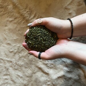 May include: A handful of dried green herbs, likely for culinary or medicinal use.