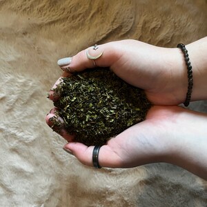 May include: A handful of dried green herbs, likely for culinary or medicinal use.