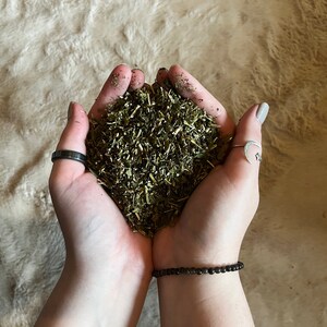 May include: A handful of dried green herbs, likely for tea or cooking.
