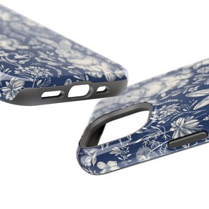 May include: A blue phone case with a white floral pattern. The case has a raised edge around the camera lens and buttons.