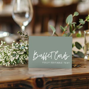 May include: A sage green buffet card with white script text that reads "Buffet Cards" and "FULLY EDITABLE TEXT". The card is on a wooden table, with flowers and a wine glass in the background.