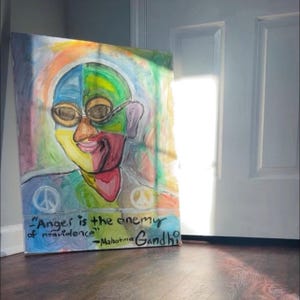May include: A colourful painting of a person with a quote by Mahatma Gandhi: "Anger is the enemy of nonviolence." The painting is done in a style that is reminiscent of abstract expressionism.