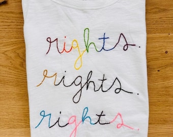 Hand embroidered t-shirt equal rights, equality, Human Rights tee rainbow colors, Afghan refugee made, Bibi Collective, trans rights, pride